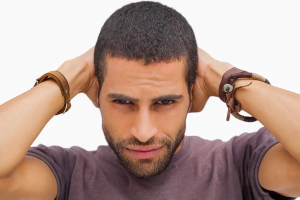 Handsome man posing with hands on head — Stock Photo, Image