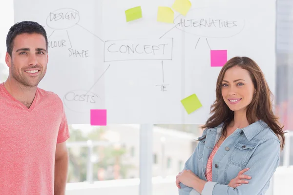 Creative team standing in front of whiteboard — Stock Photo, Image