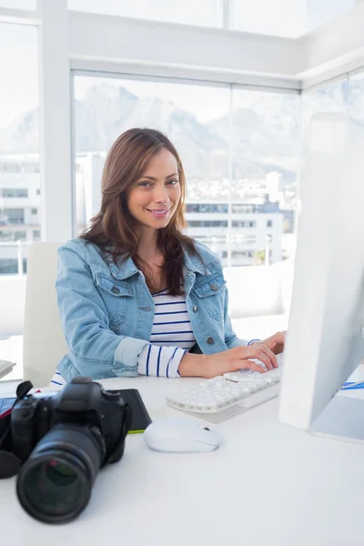 Cheerful photo editor working on computer — Stock Photo, Image