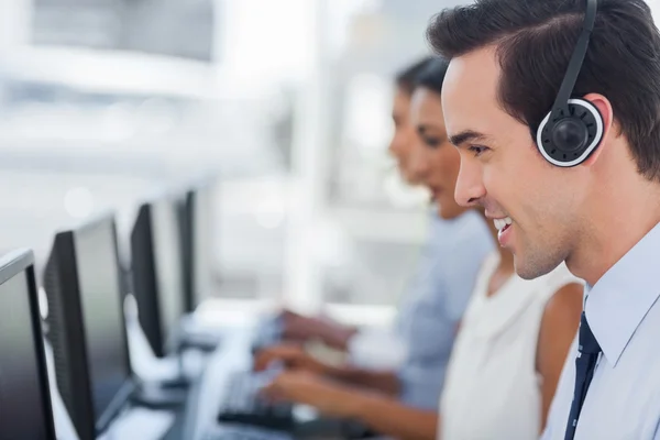 Focus on a smiling call centre agent — Stock Photo, Image