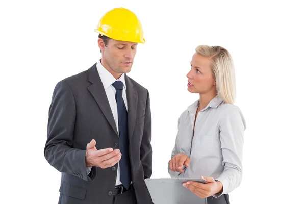 Serious young architects looking at clipboard — Stock Photo, Image