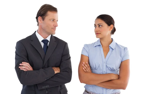 Smiling co workers looking seriously at each other — Stock Photo, Image