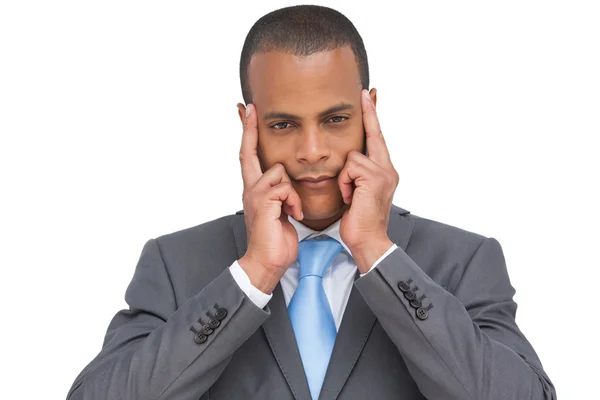 Businessman putting his fingers on his temples — Stock Photo, Image