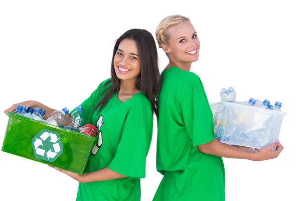 Enivromental activists holding box of recyclables and standing back to back — Stock Photo, Image