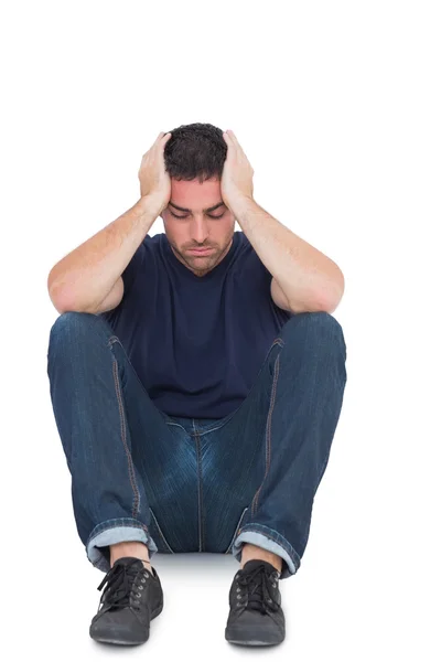 Sitting upset man with head between hands — Stock Photo, Image