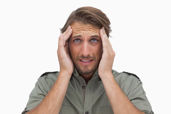 Man grimacing with pain of headache and looking up — Stock Photo, Image