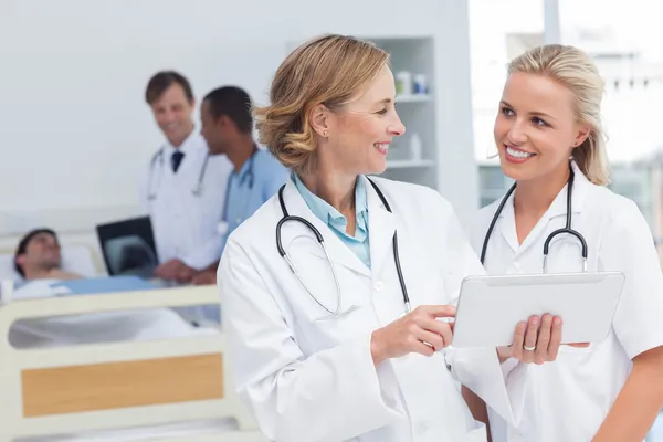 Smiling doctors talking to each other — Stock Photo, Image