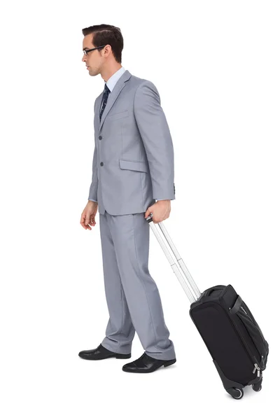 Young businessman with glasses holding a trolley — Stock Photo, Image