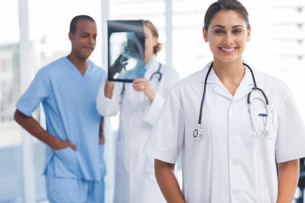 Woman doctor standing in a bright hospital — Stock Photo, Image