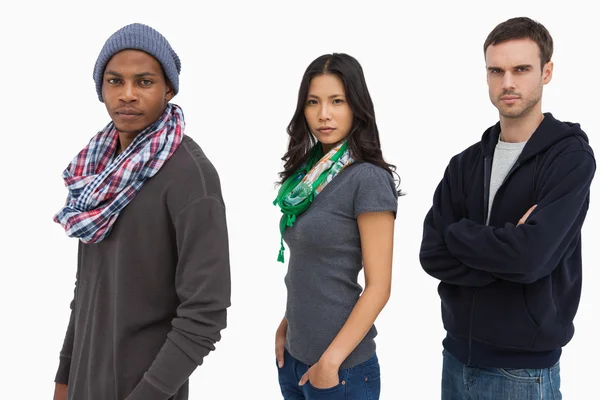 Stylish young in a row looking serious — Stock Photo, Image