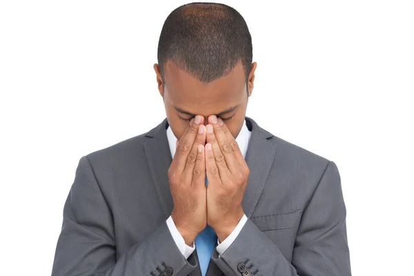 Businessman holding his head between hands — Stock Photo, Image