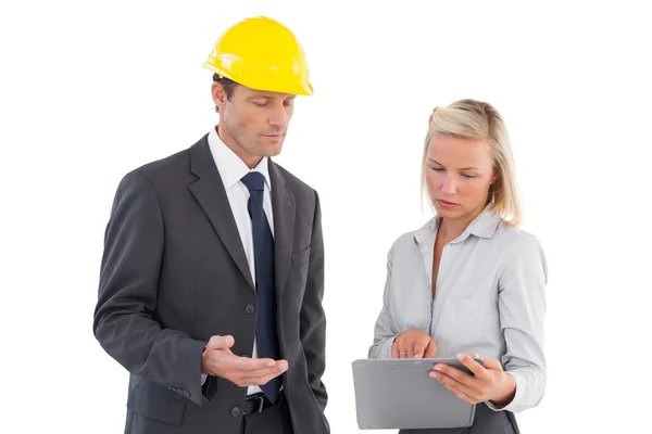 Serious architects looking at clipboard — Stock Photo, Image