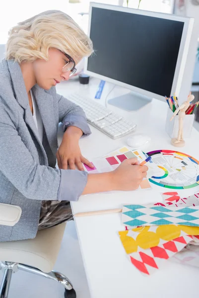 Interior designer looking at colour charts — Stock Photo, Image