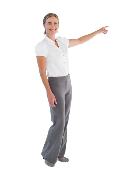 Smiling businesswoman pointing — Stock Photo, Image