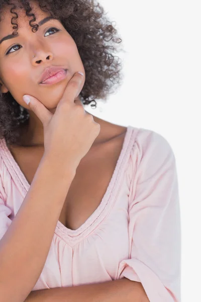 Pretty woman looking thoughtful with hand on chin — Stock Photo, Image