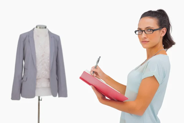 Designer looking at camera and taking notes — Stock Photo, Image