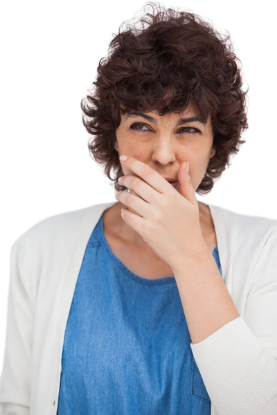Brunette woman with hand on her mouth — Stock Photo, Image