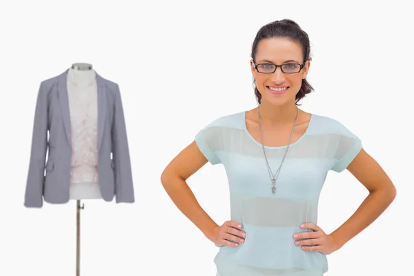 Happy designer looking at camera with hands on hips — Stock Photo, Image