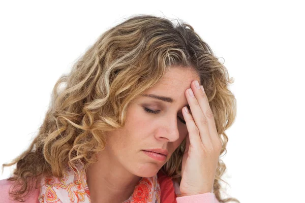 Blonde woman suffering with headache thus holding her head — Stock Photo, Image