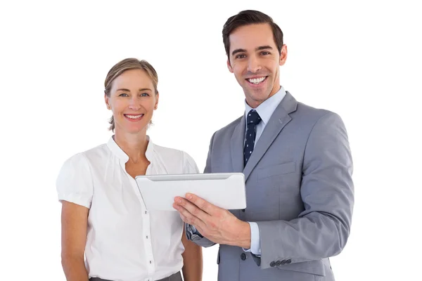 Smiling co workers using a tablet pc — Stock Photo, Image
