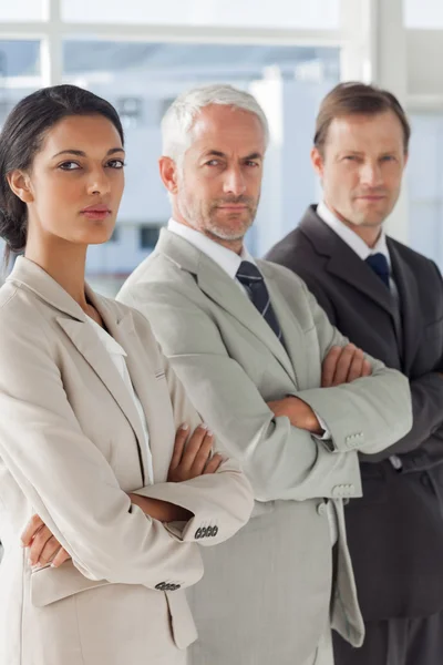 Three serious business standing together — Stock Photo, Image