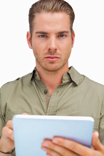 Serious man using tablet pc looking at camera — Stock Photo, Image