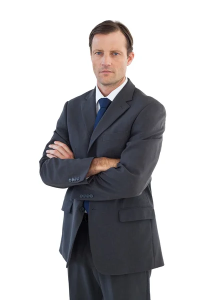 Charismatic businessman standing with arms crossed Royalty Free Stock Images