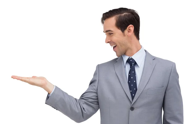 Young businessman looking at his hand Stock Picture