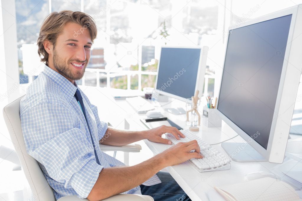 Smiling designer working at his desk Stock Photo by ©Wavebreakmedia