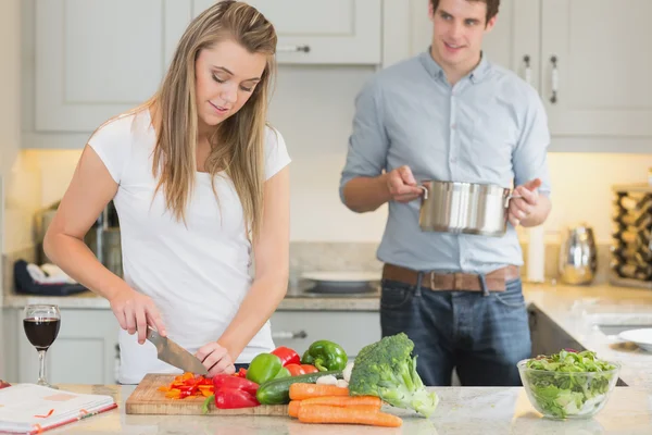 Man helping woman with cooking — Stock Photo, Image