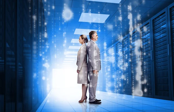 Business standing back to back in data center — Stock Photo, Image