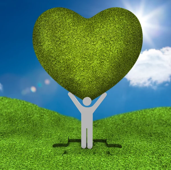 Human representation holding a big green heart — Stock Photo, Image