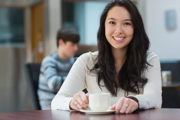 Happy student sitting in a coffee shop — Stock Photo, Image