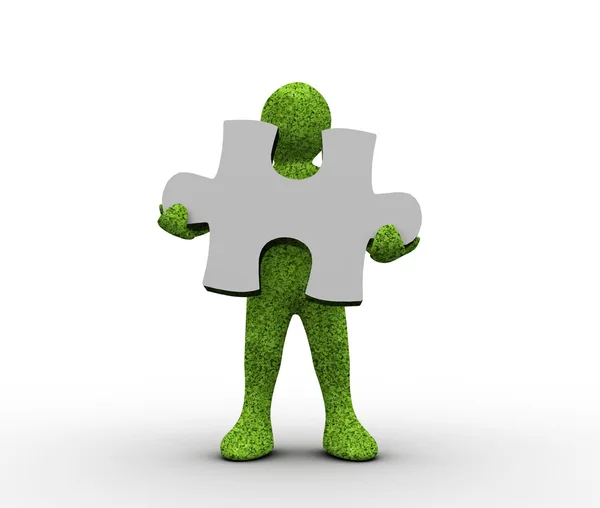 Green character holding a jigsaw piece — Stock Photo, Image