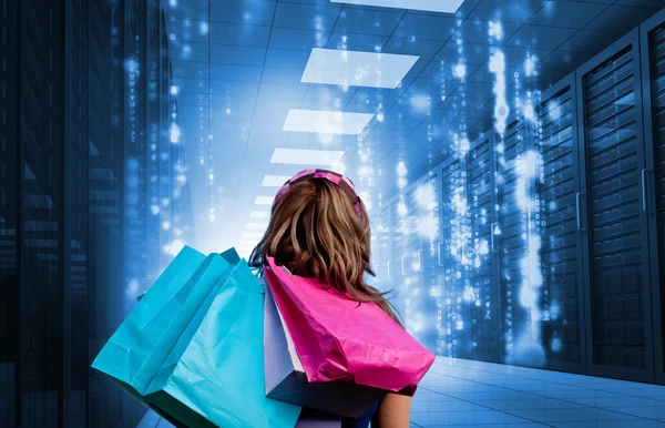 Girl with shopping bags looking at falling matrix — Stockfoto