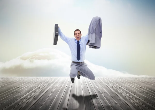 Stressed businessman jumping over wooden boards — Stock Photo, Image