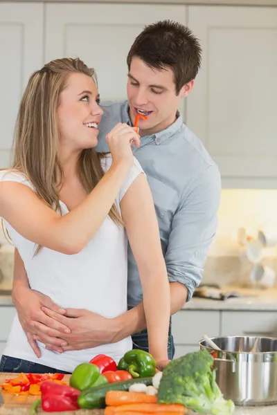 Woman having fun by feeding man — Stock Photo, Image