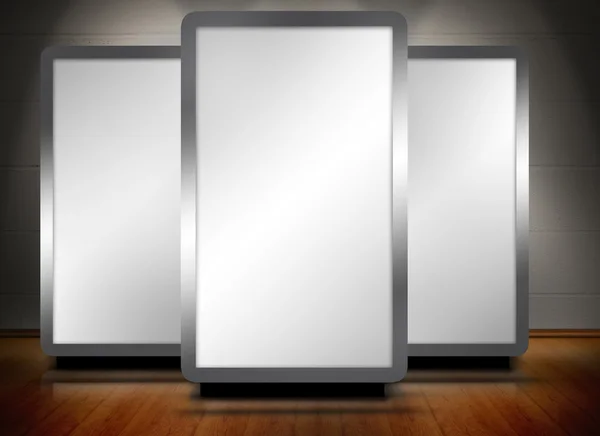 Three blank screens standing on wooden floor — Stock Photo, Image
