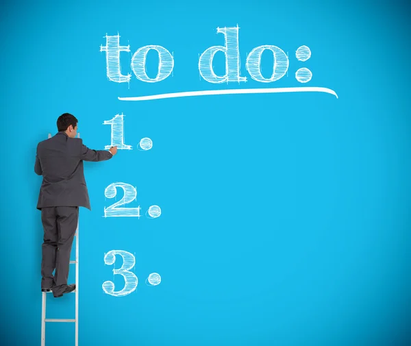 Businessman writing a to do list on a giant wall — Stock Photo, Image