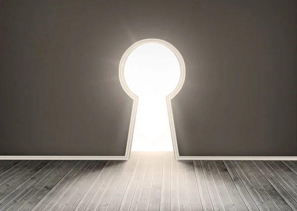 Door shaped keyhole showing bright light — Stock Photo, Image