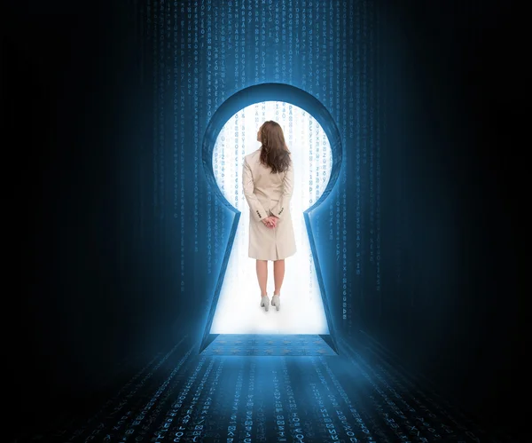 Businesswoman standing in keyhole doorway — Stock Photo, Image