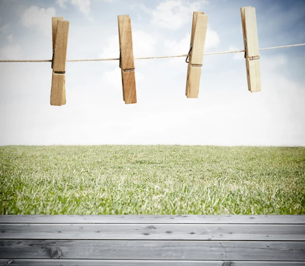 Clothespin on a laundry line outside with bright blue sky Stock Photo