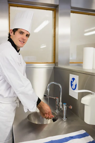 Cheerful chef washing hands — Stock Photo, Image