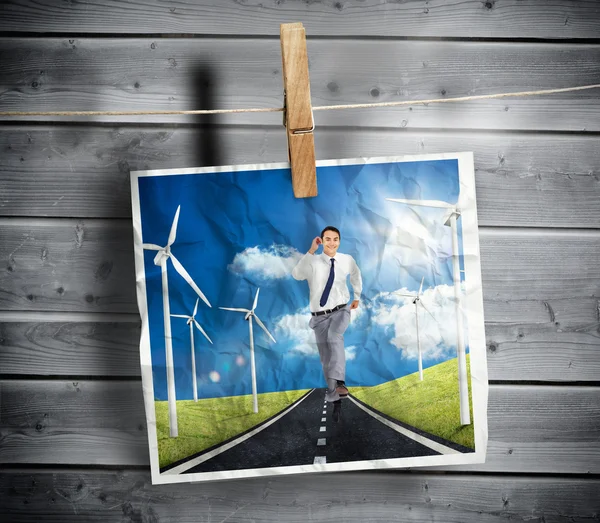 Photo of businessman running on a road hung on a line — Stock Photo, Image