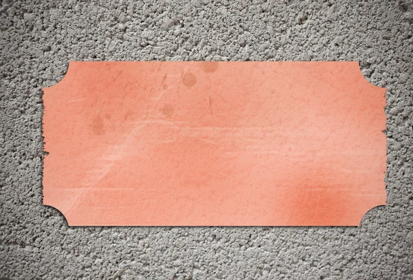 Cartel espacio copia naranja pegado en una pared de guijarros — Foto de Stock