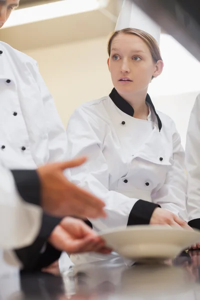 Trainee chef listening to teacher — Stock Photo, Image