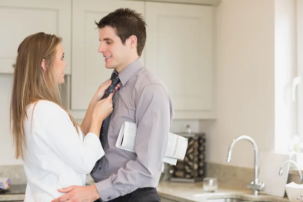 Wife fixing husbands tie — Stock Photo, Image