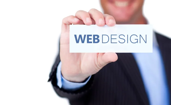 Empresario sosteniendo una etiqueta con diseño web escrito en ella — Foto de Stock