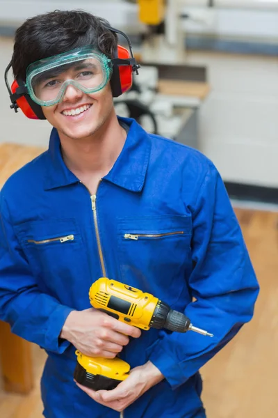 Student standing while holding a driller — Stock Photo, Image