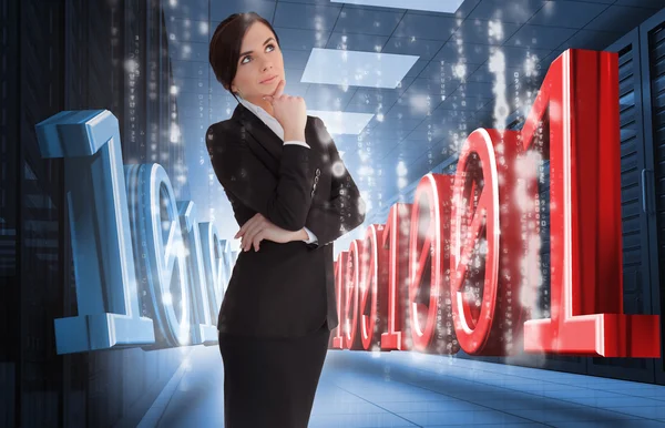 Businesswoman thinking of binary code in data center — Stock Photo, Image